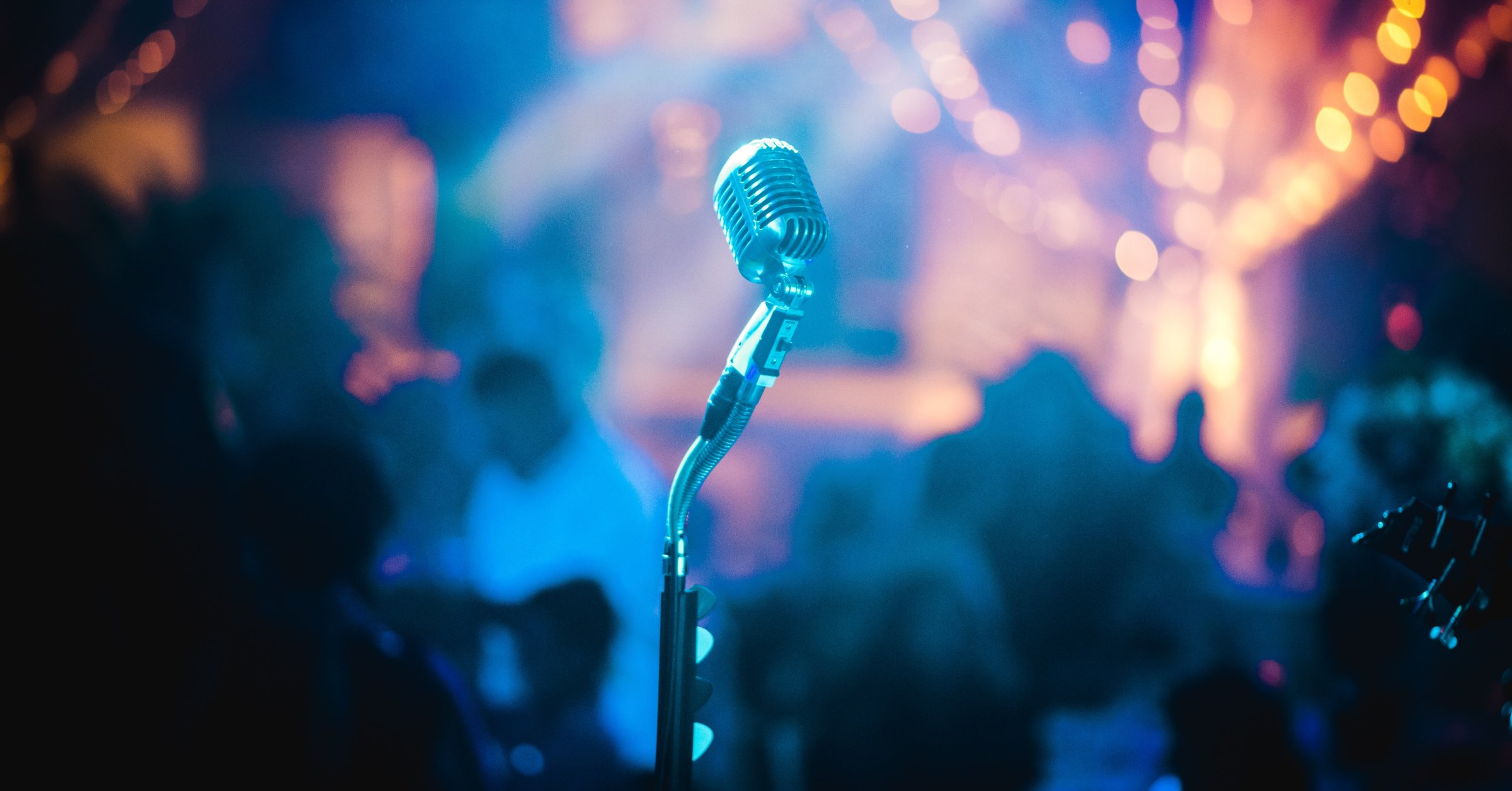 Vintage microphone lit on a live music stage